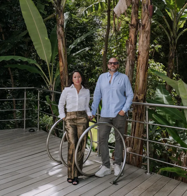 Vanessa and Francisco on a terrace surrounded by tropical vegetation